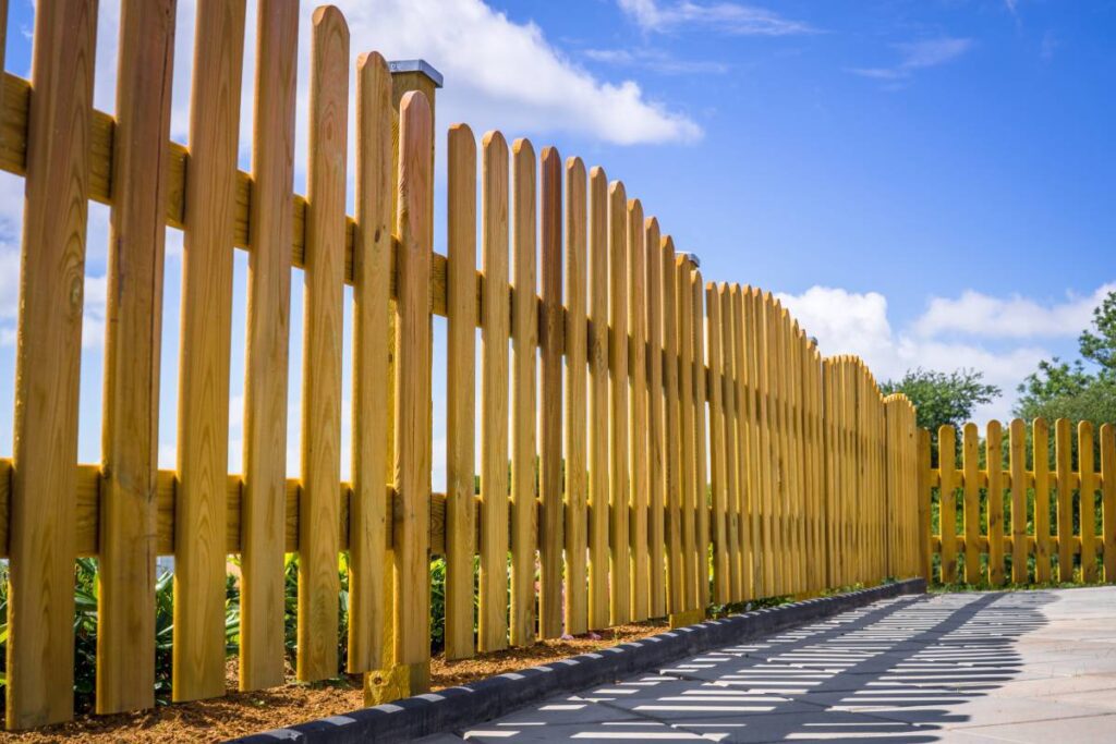 Wooden picket fence surrounding a concrete driveway near Nicholasville, KY